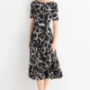 Fit & flare dress with belt - floral - textured black / white